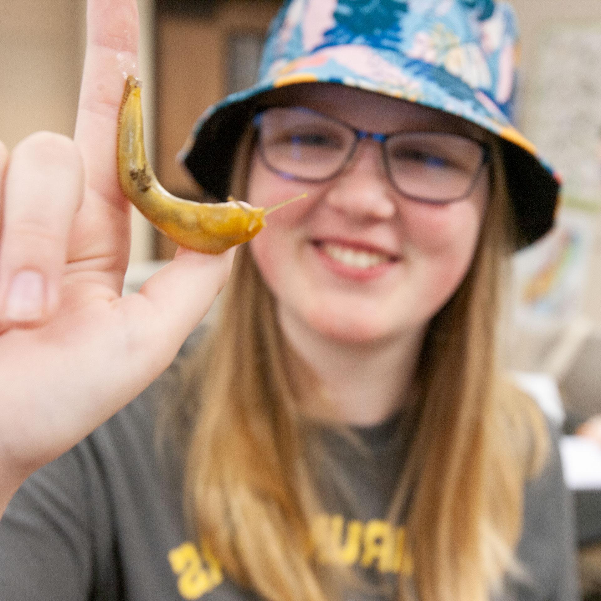 Biology student with a slug